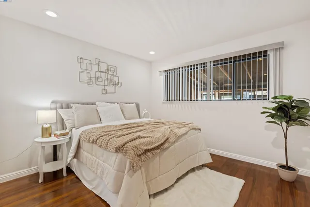 a bedroom with a bed and a window