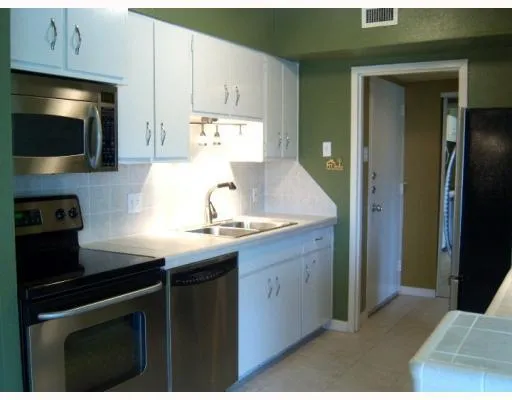 a kitchen with stainless steel appliances a sink a stove and a refrigerator