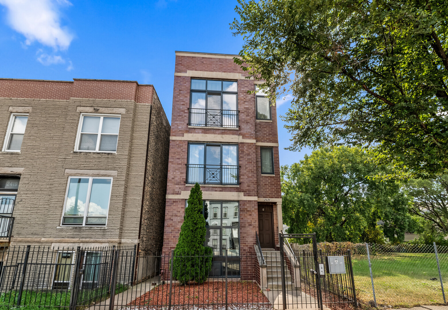2421 West Warren Boulevard, Unit 3 Chicago, IL 60612 - Photo 1 of 14 a view of a brick building next to a yard