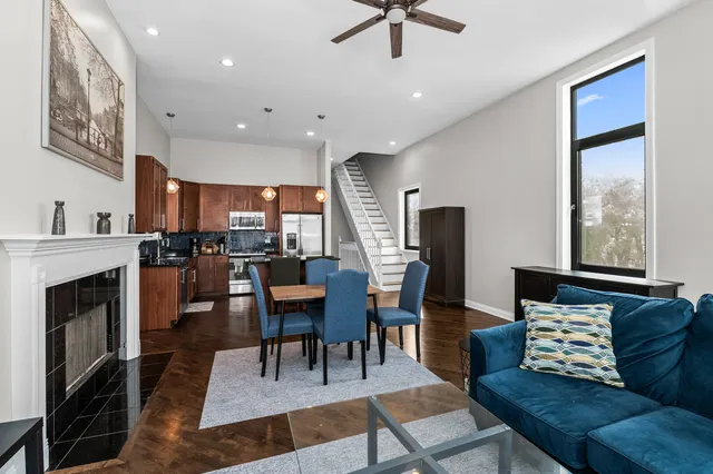a living room with furniture a fireplace and a flat screen tv