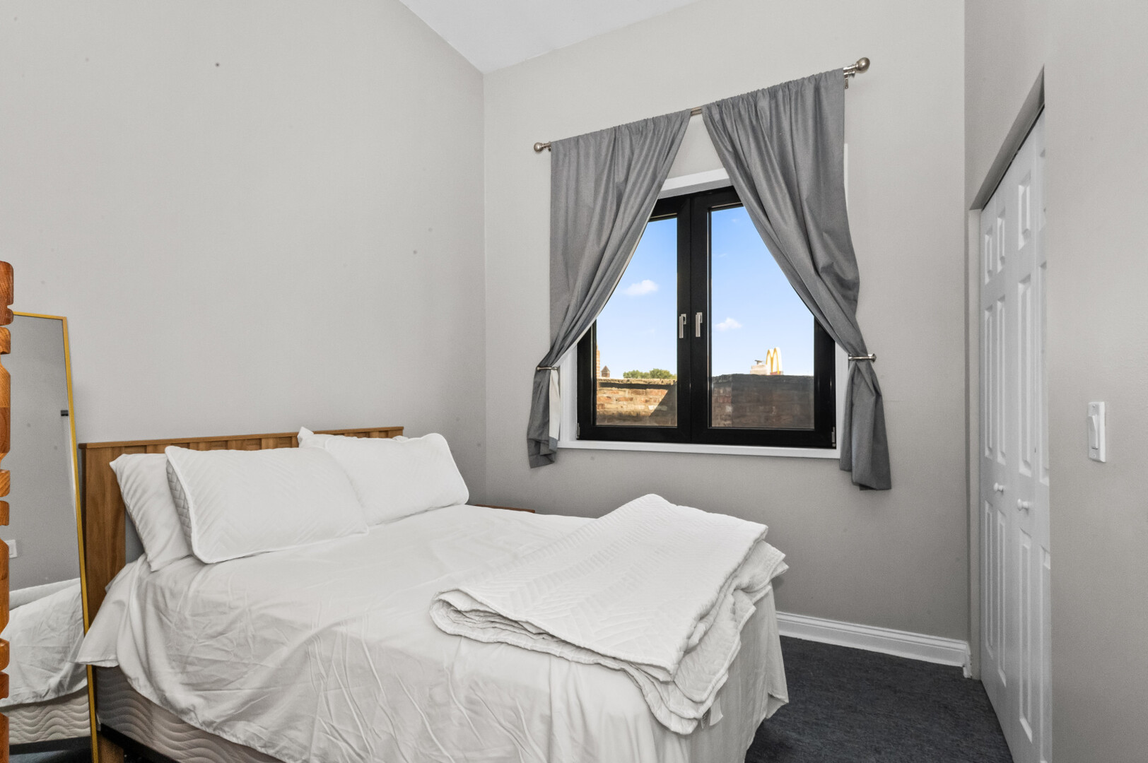 2421 West Warren Boulevard, Unit 3 Chicago, IL 60612 - Photo 7 of 14 a bedroom with a bed and a large window