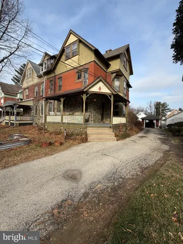 a front view of a building with parking space