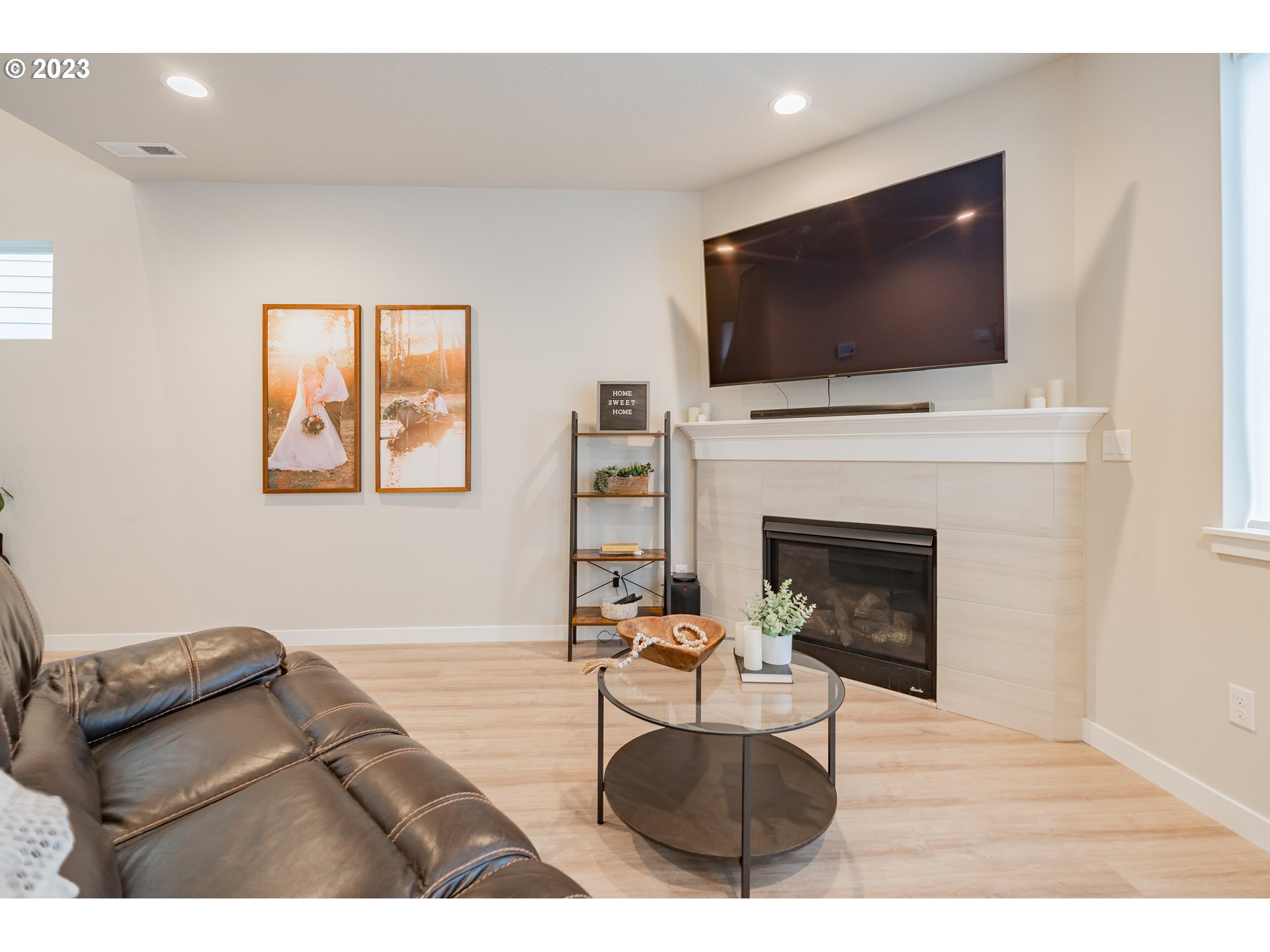8614 North 2nd Loop Ridgefield, WA 98642 - Photo 5 of 30 a living room with furniture a flat screen tv and a fireplace