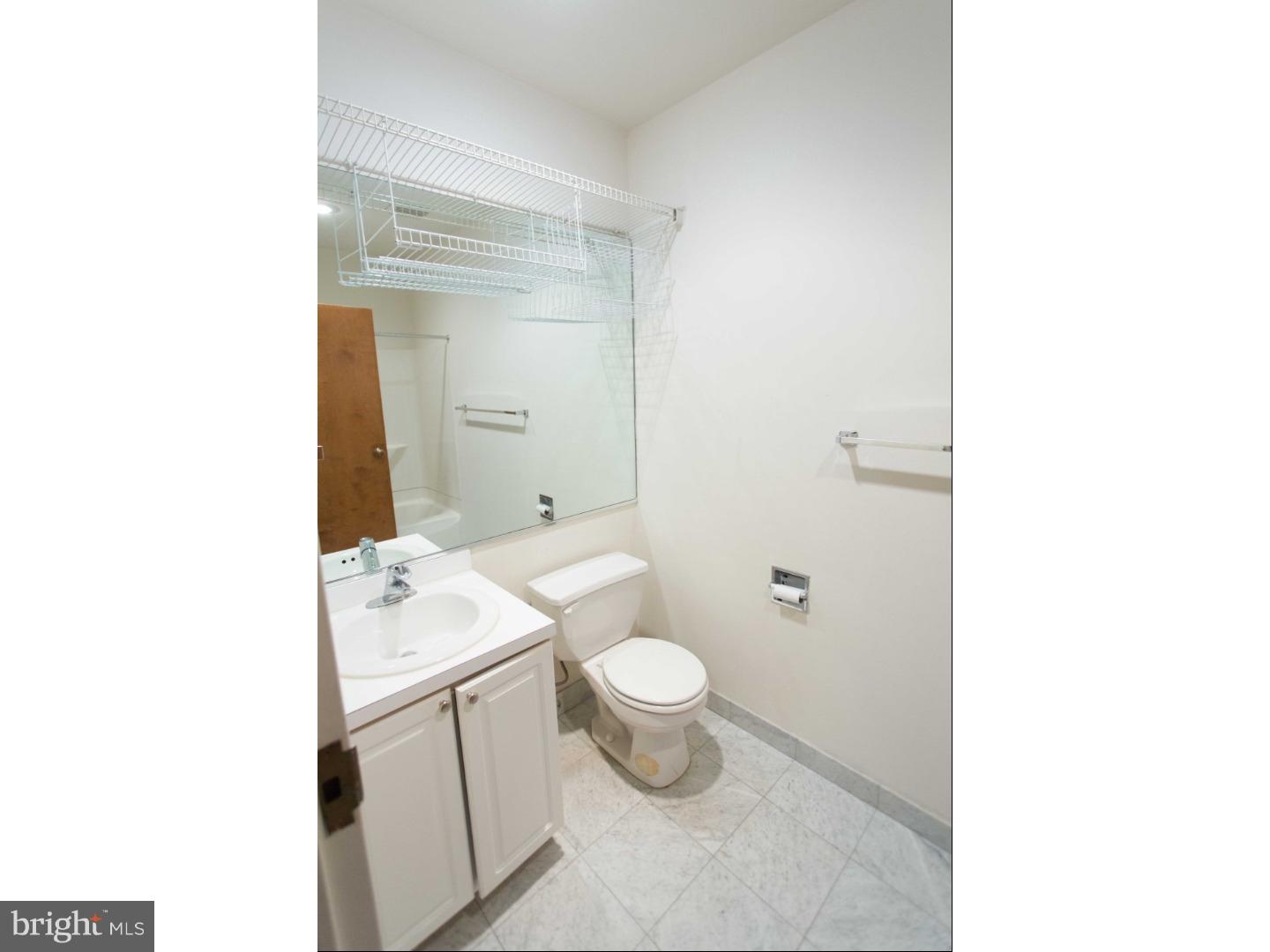 1411-3 Walnut Street, Unit 502 Philadelphia, PA 19102 - Photo 13 of 15 a bathroom with a granite countertop toilet and a sink