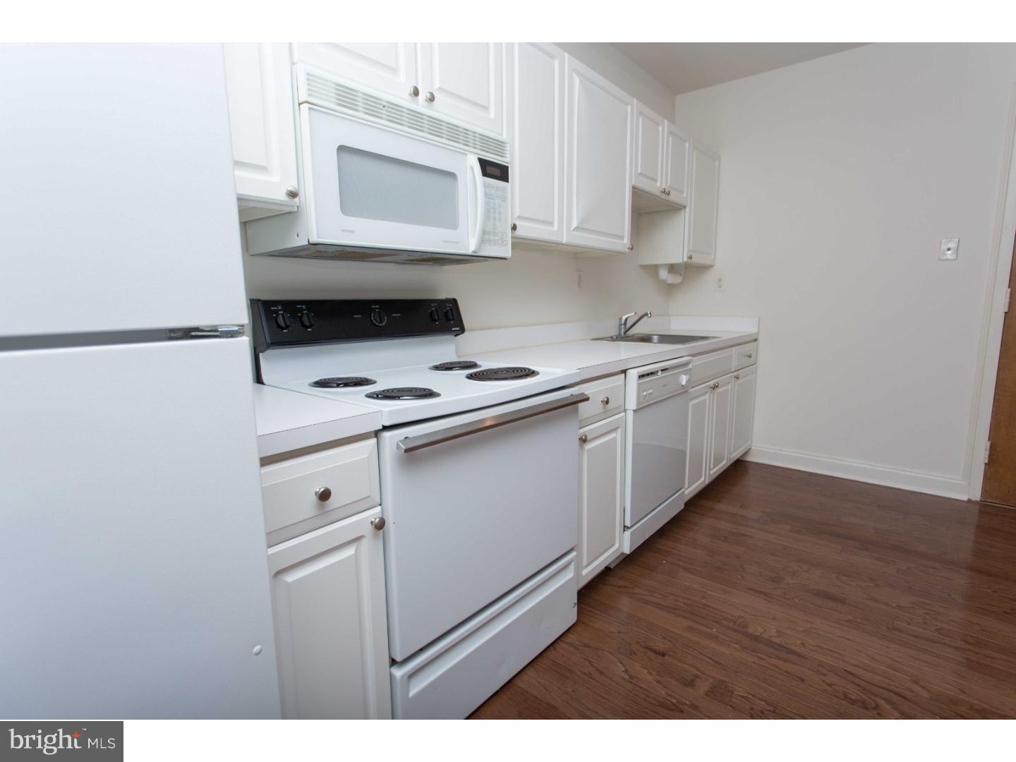1411-3 Walnut Street, Unit 502 Philadelphia, PA 19102 - Photo 7 of 15 a kitchen with stainless steel appliances a stove microwave and sink