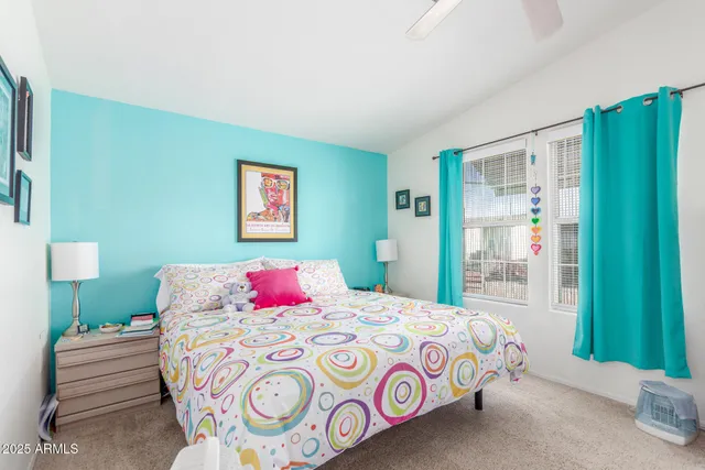 a bedroom with a bed and a painting on the wall