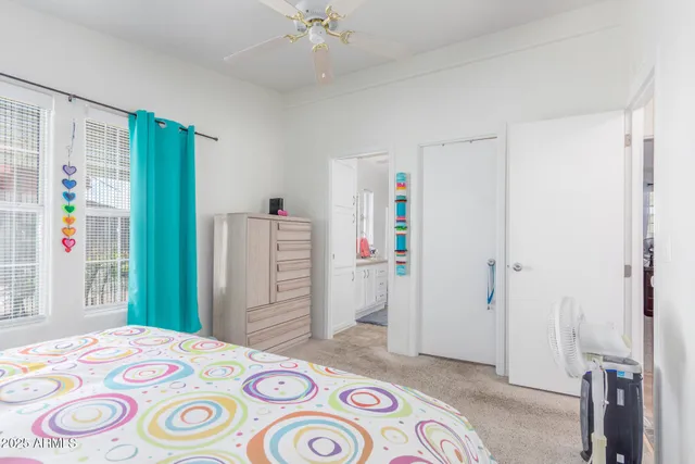 a bedroom with a bed and a dresser in it