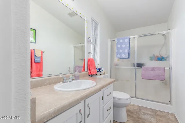 a bathroom with a sink vanity granite and toilet