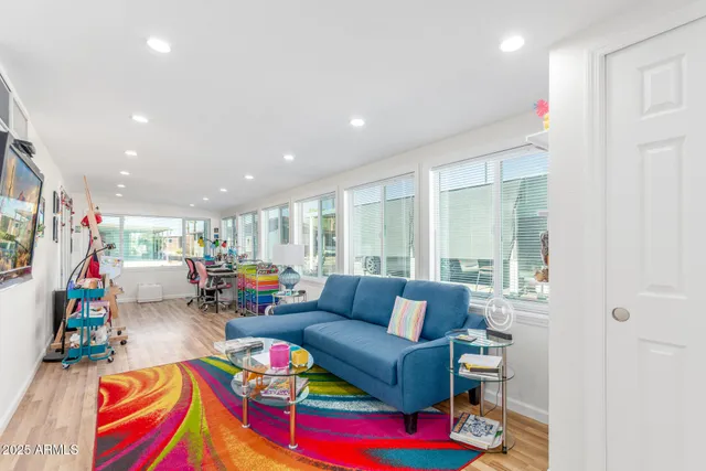 a living room with furniture and a wooden floor