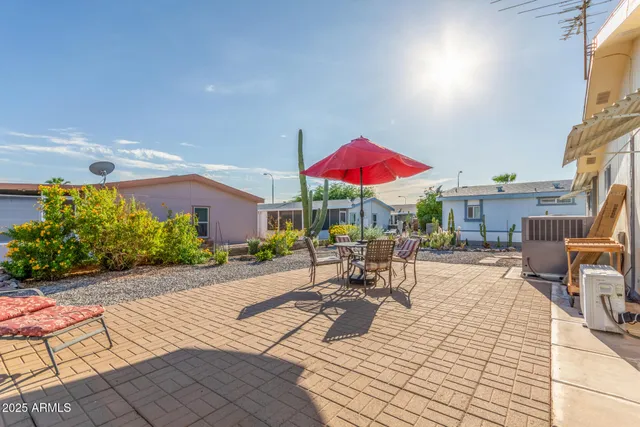 a view of a patio with a table and chairs under an umbrella with wooden floor