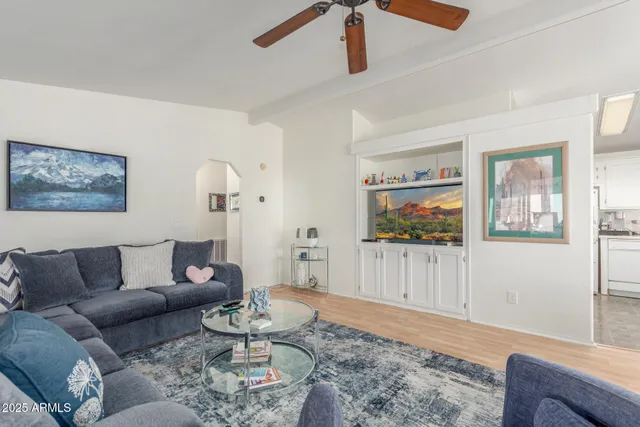 a living room with furniture and a wooden floor