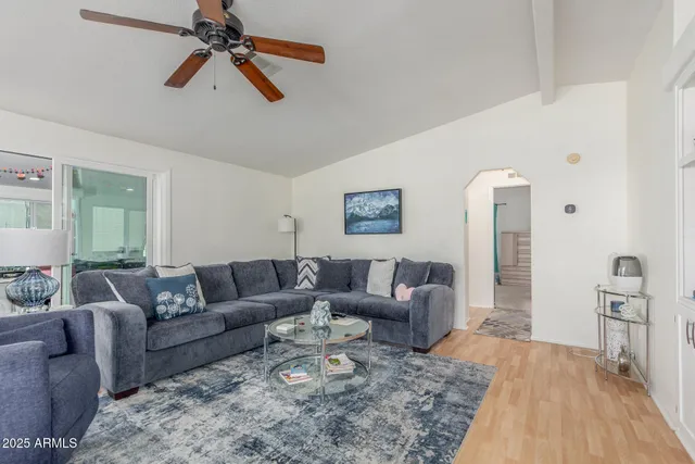 a living room with furniture and a wooden floor