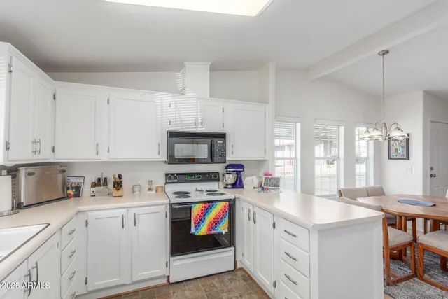 a kitchen with stainless steel appliances a stove a sink a stove a refrigerator and cabinets