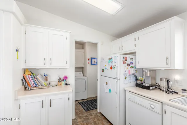 a white refrigerator freezer sitting inside of a kitchen