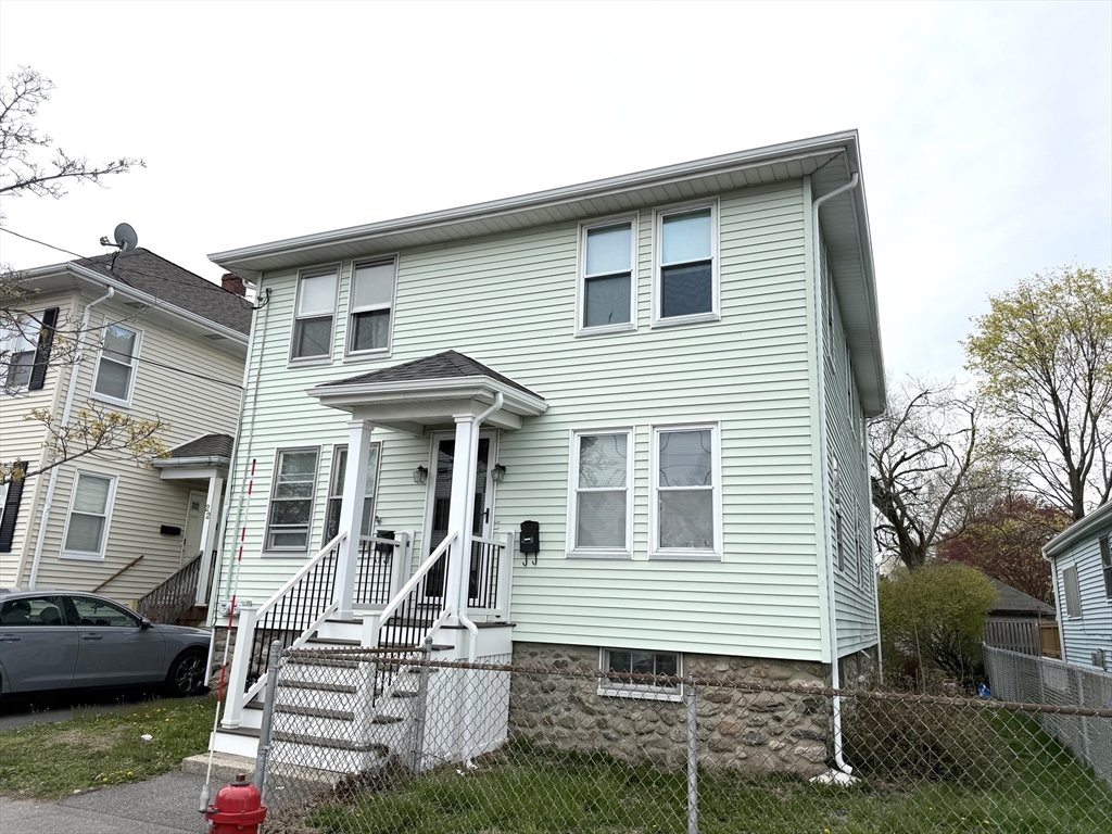 26 Harrison Street, Unit 1 Quincy, MA 02169 - Photo 12 of 14 a front view of a house with stairs