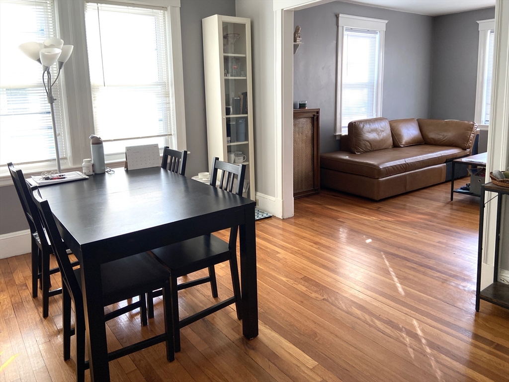 26 Harrison Street, Unit 1 Quincy, MA 02169 - Photo 4 of 14 a living room with furniture wooden floor and a table
