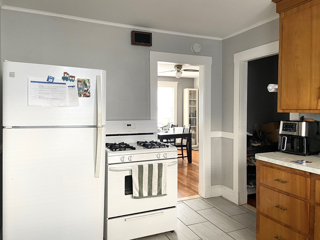26 Harrison Street, Unit 1 Quincy, MA 02169 - Photo 7 of 14 a kitchen with a stove and a refrigerator