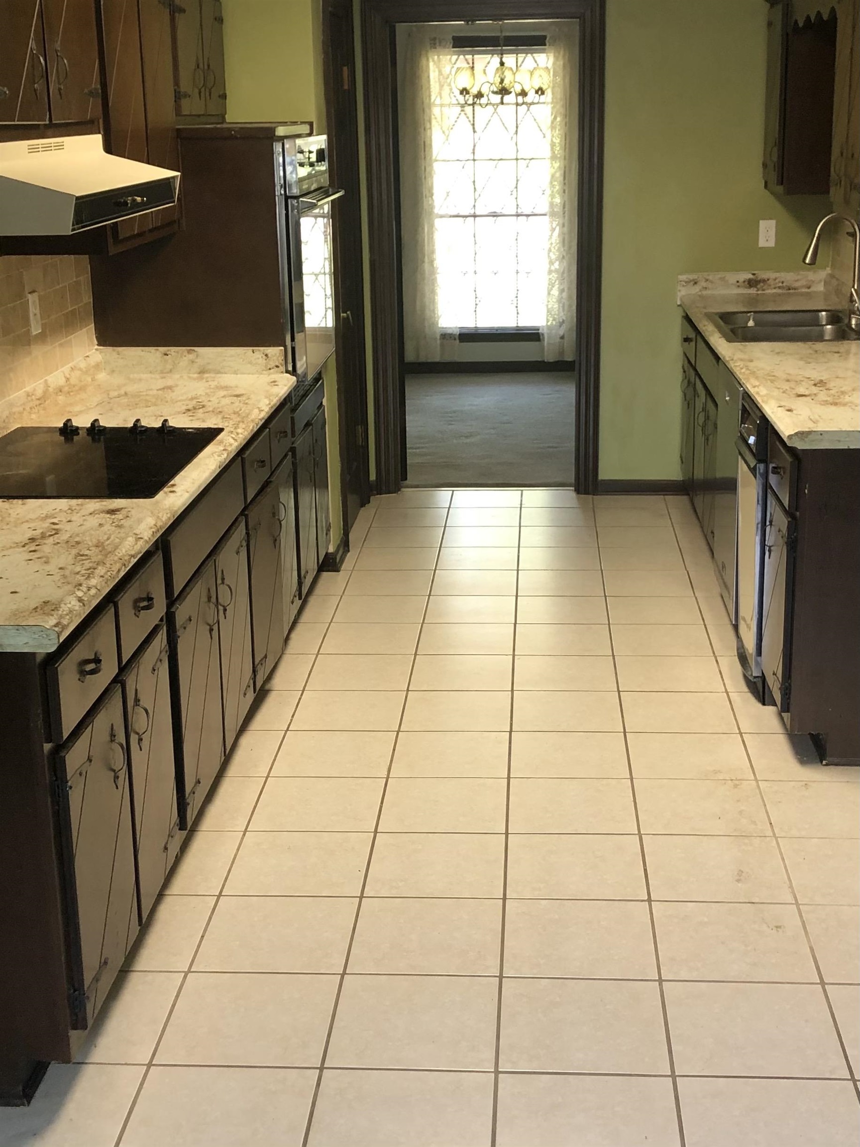 7656 Hollow Fork Road Germantown, TN 38138 - Photo 2 of 5 a kitchen with stainless steel appliances granite countertop a sink and a stove