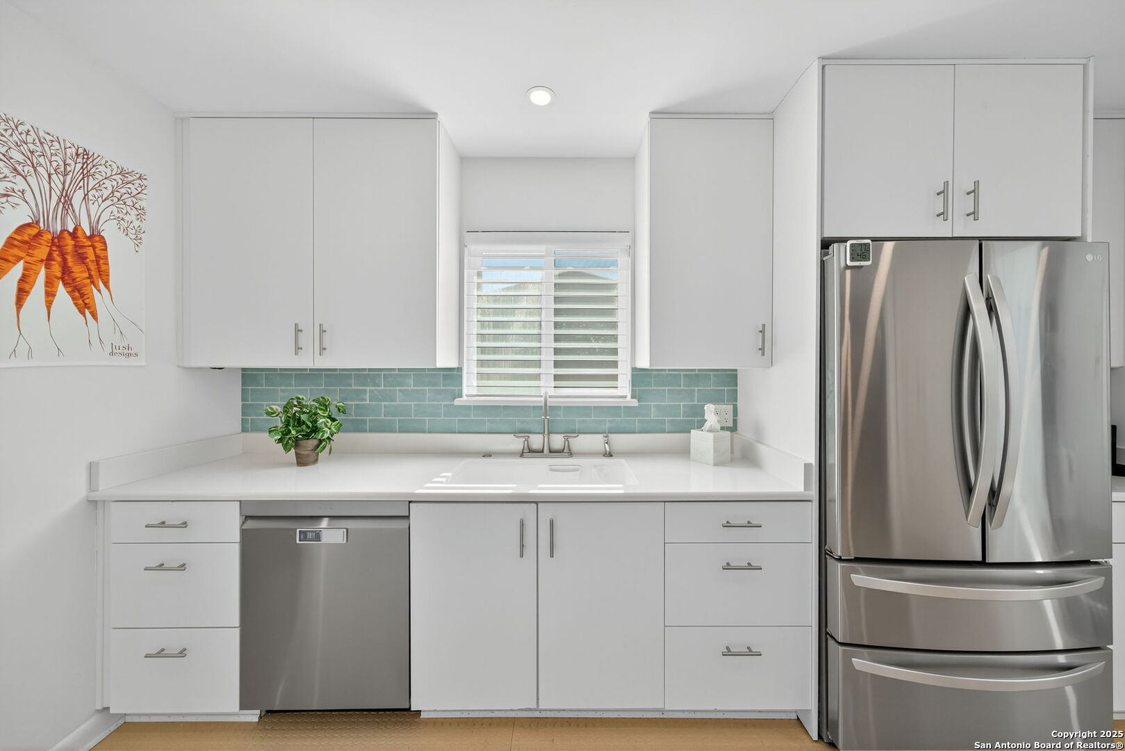300 Towne Vue Drive Castle Hills, TX 78213 - Photo 11 of 31 a kitchen with white cabinets and stainless steel appliances