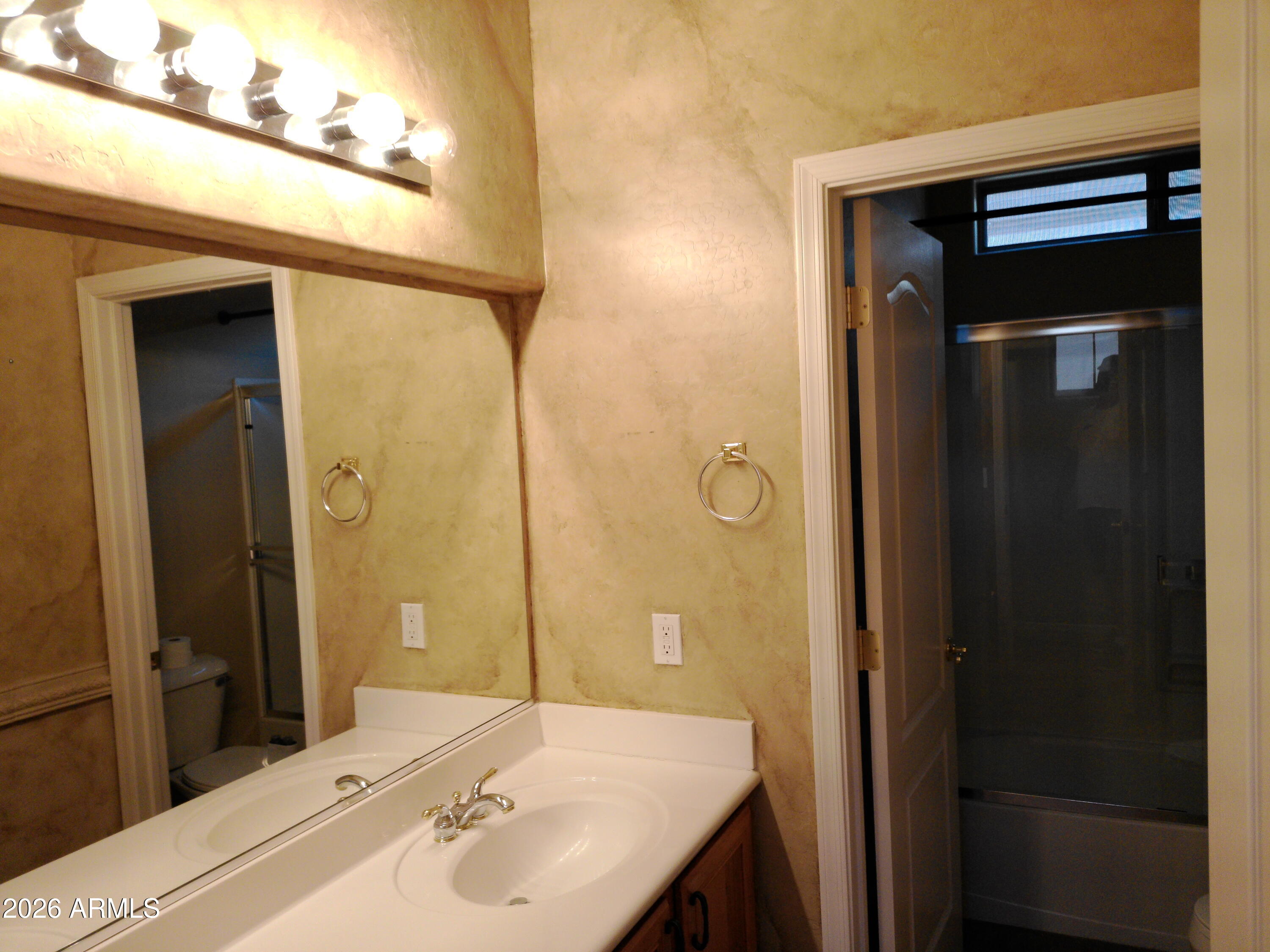 3018 West Sentinel Rock Road Phoenix, AZ 85086 - Photo 12 of 16 a bathroom with a sink and a mirror