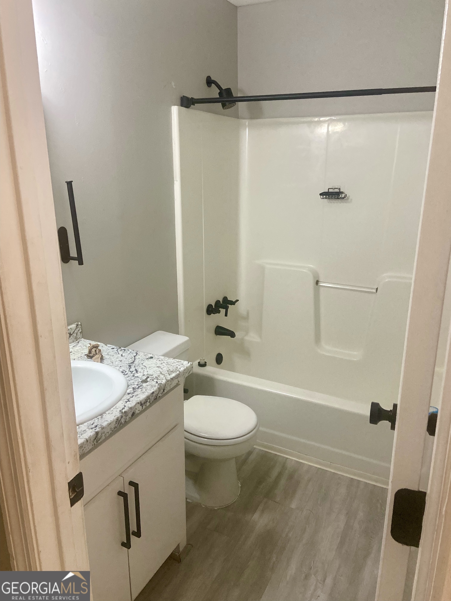 2216 Hunter Court Columbus, GA 31907 - Photo 14 of 16 a bathroom with a granite countertop sink toilet and shower