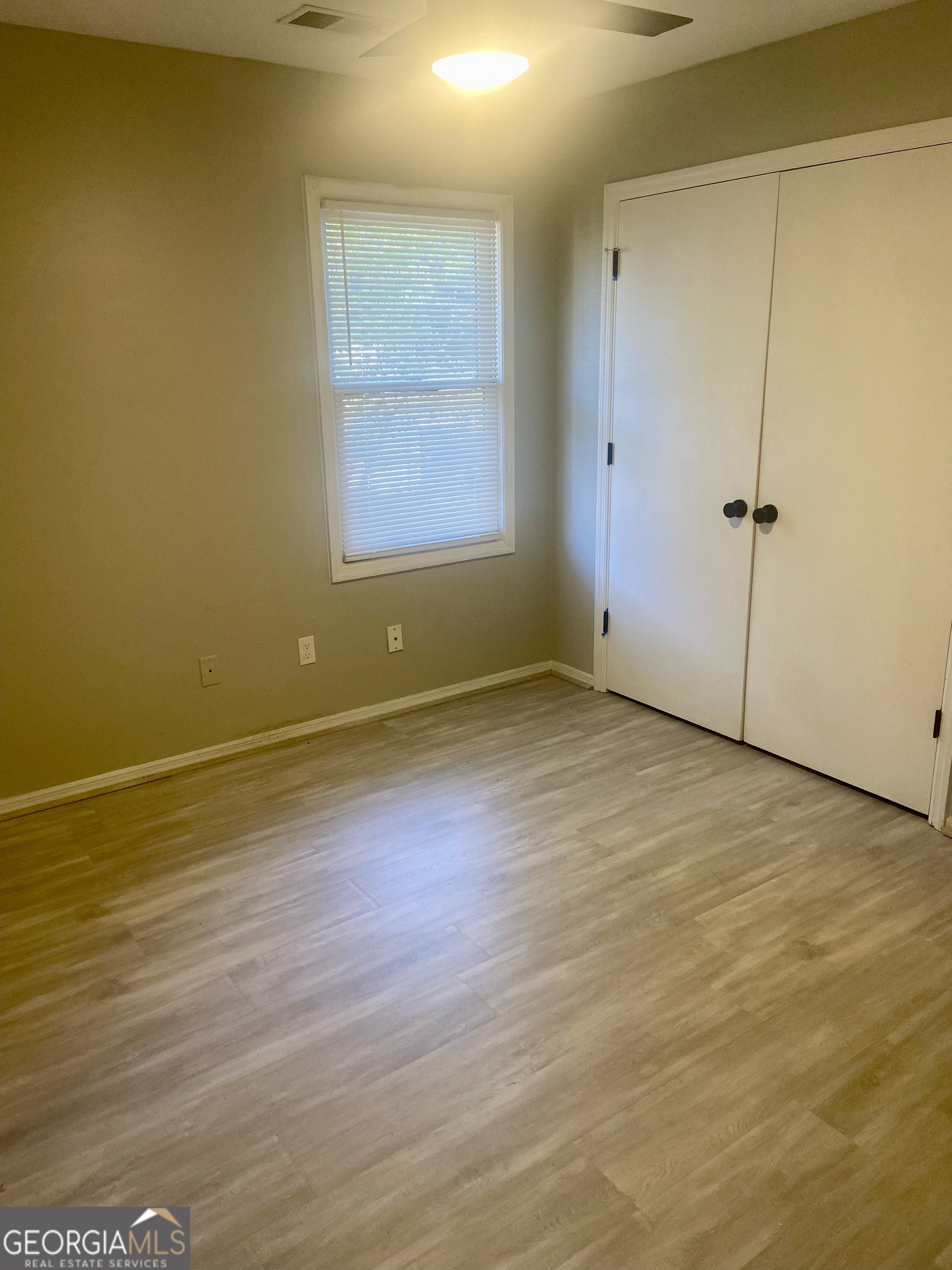 2216 Hunter Court Columbus, GA 31907 - Photo 16 of 16 an empty room with wooden floor and windows