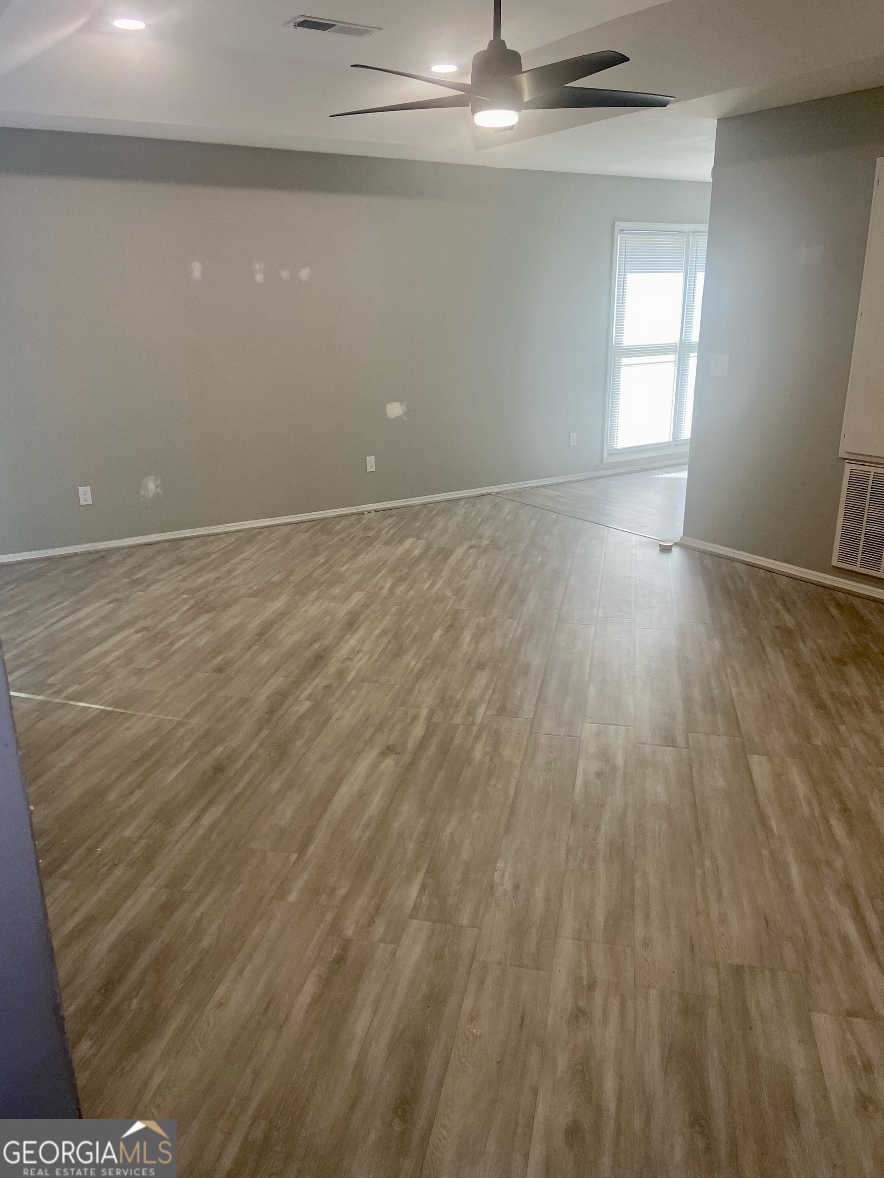 2216 Hunter Court Columbus, GA 31907 - Photo 7 of 16 a view of an empty room with wooden floor and a window
