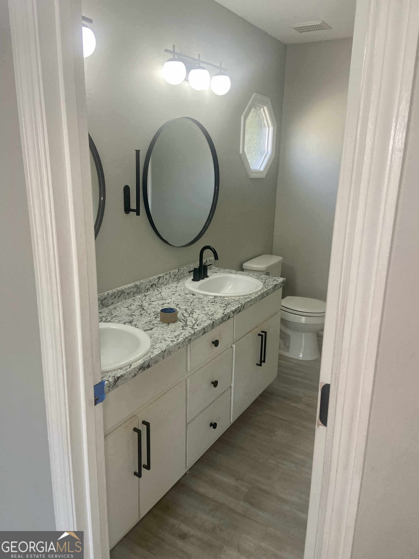 2216 Hunter Court Columbus, GA 31907 - Photo 10 of 16 a bathroom with a granite countertop toilet sink and mirror