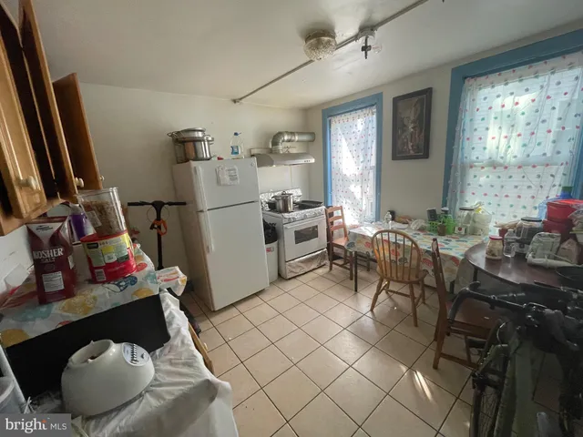 a kitchen with sink refrigerator and window