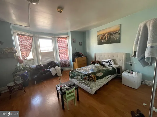 a bedroom with furniture and a wooden floor