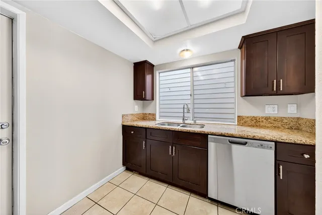 a kitchen with granite countertop a sink and cabinets