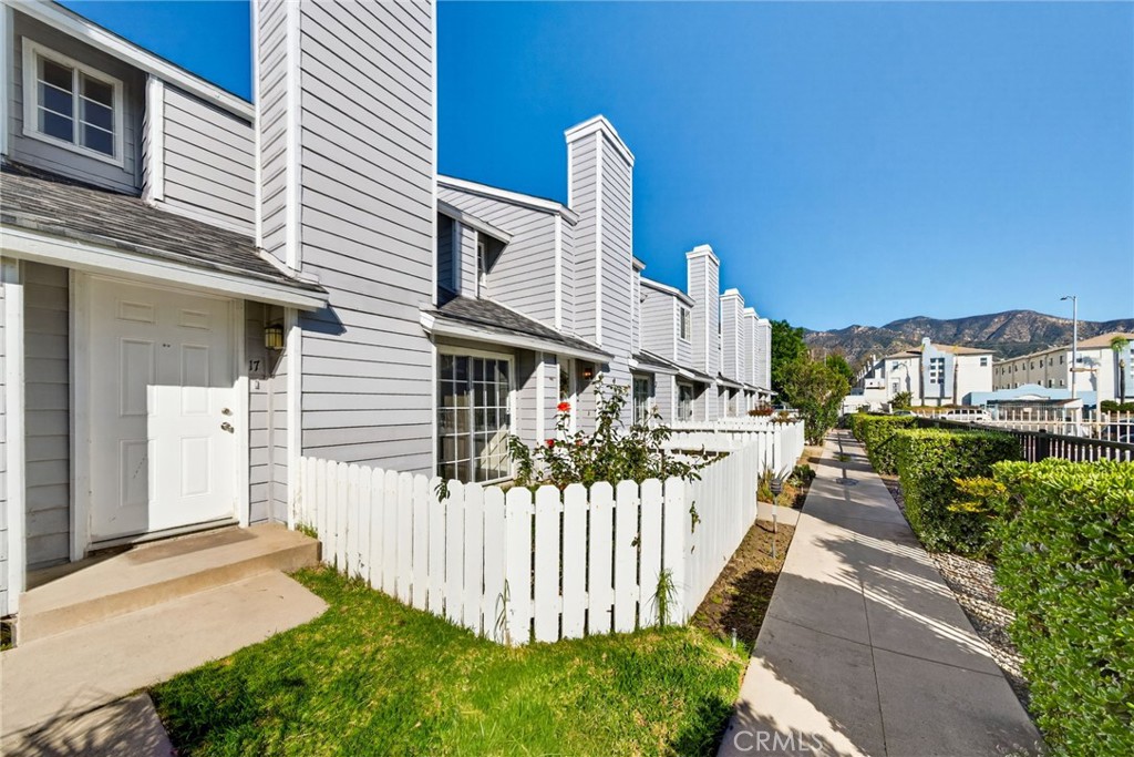 14380 Foothill Boulevard Sylmar, CA 91342 - Photo 2 of 27 a front view of a house with wooden fence