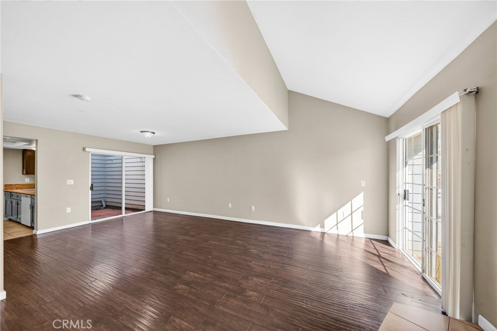 14380 Foothill Boulevard Sylmar, CA 91342 - Photo 7 of 27 a view of an empty room with wooden floor and a window