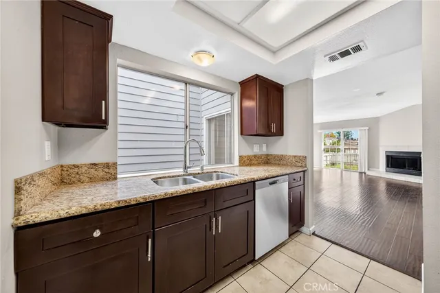 a kitchen with a sink window and cabinets