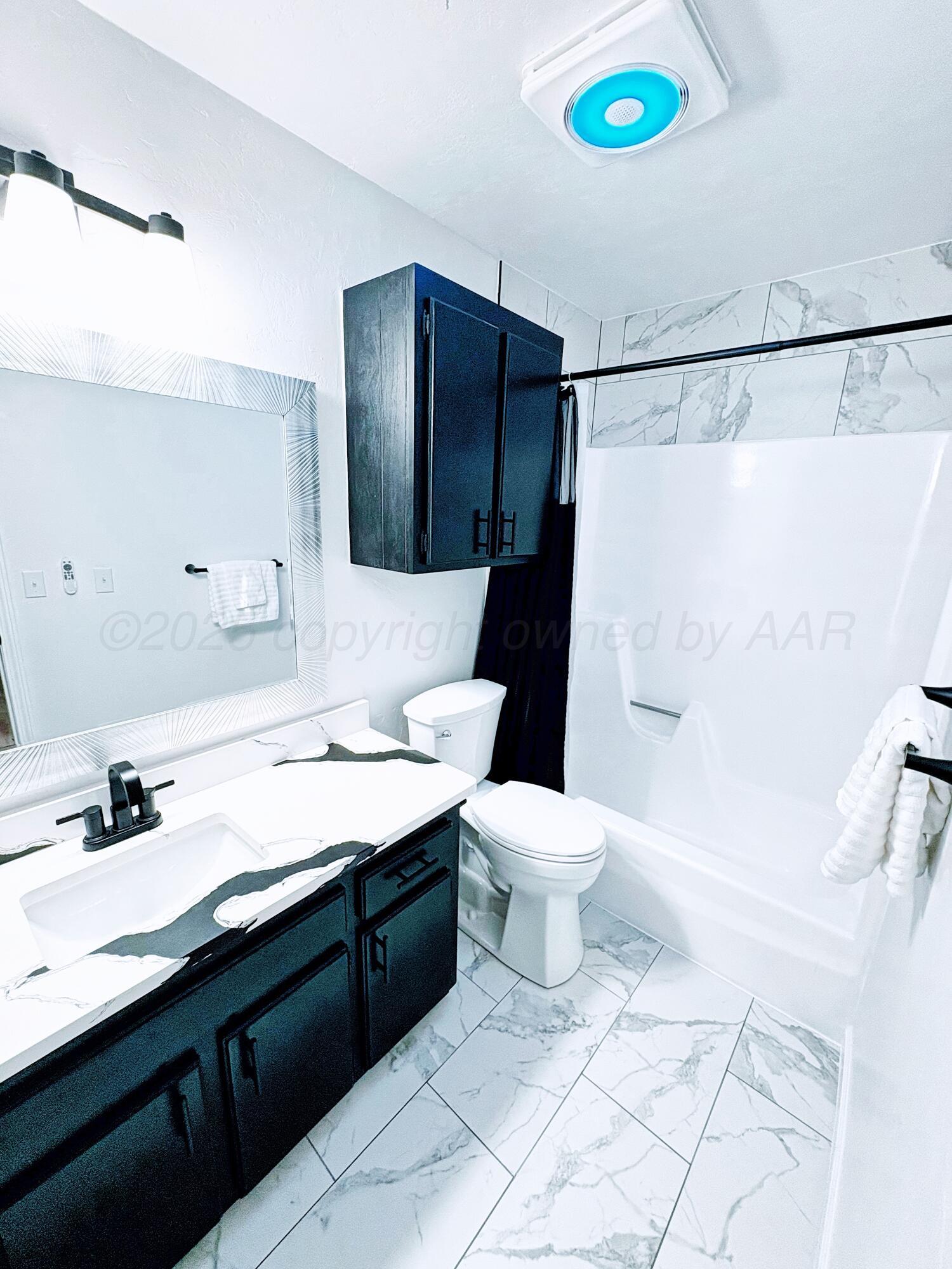 2310 Texas Street Perryton, TX 79070 - Photo 17 of 26 a bathroom with a sink toilet and shower