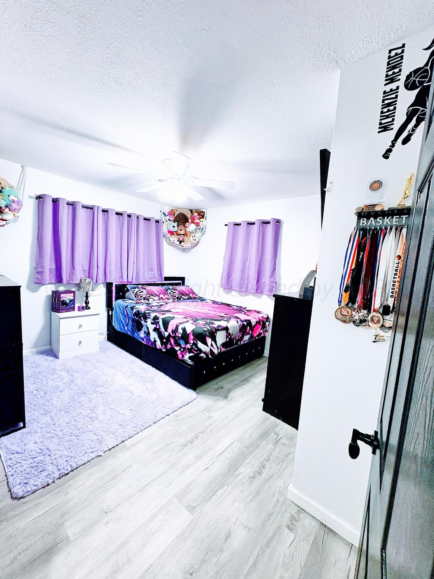 2310 Texas Street Perryton, TX 79070 - Photo 20 of 26 a bedroom with a bed and a large mirror