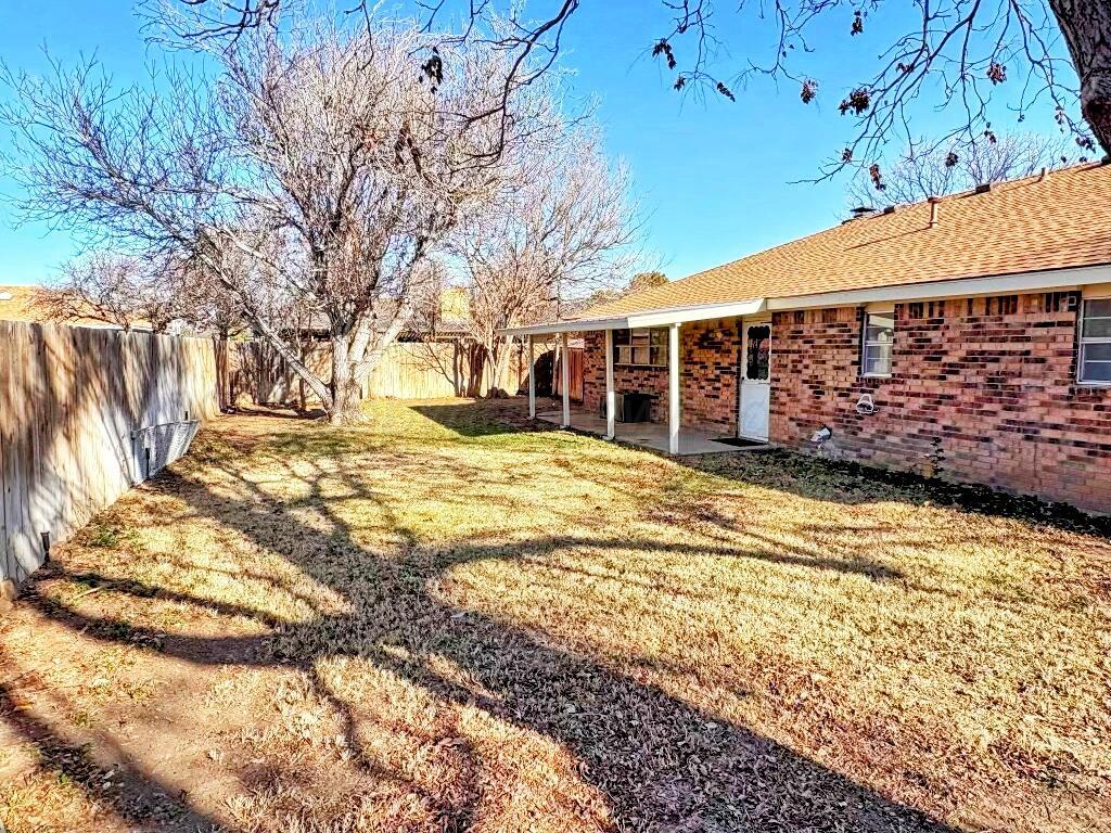 2310 Texas Street Perryton, TX 79070 - Photo 24 of 26 a view of a house with backyard and tree