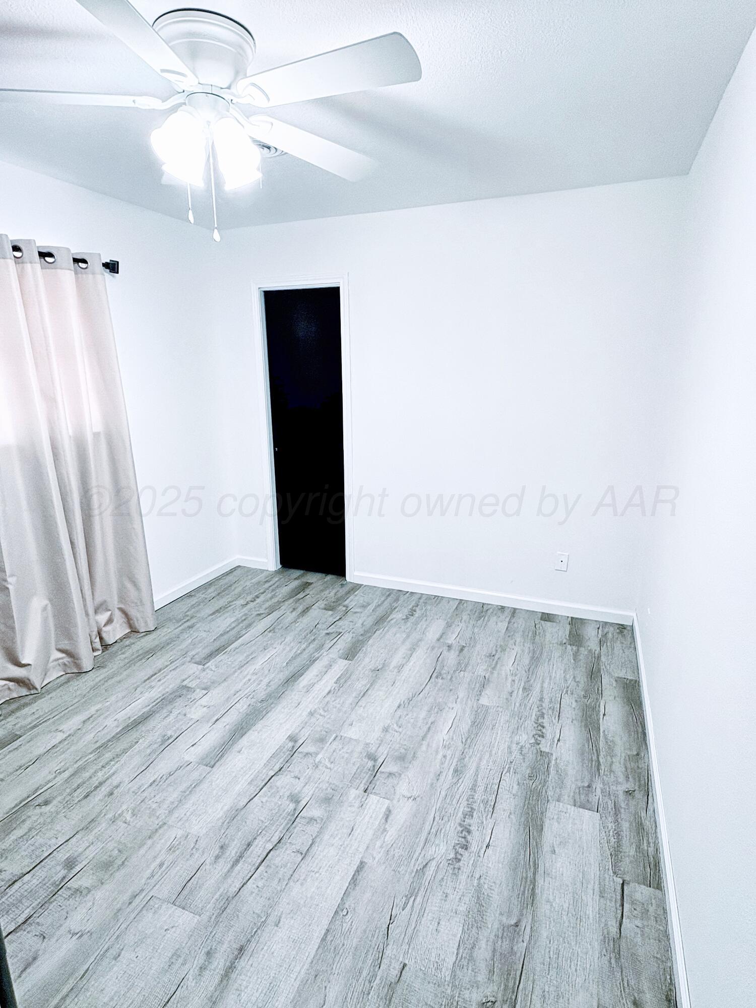 2310 Texas Street Perryton, TX 79070 - Photo 3 of 26 wooden floor in an empty room