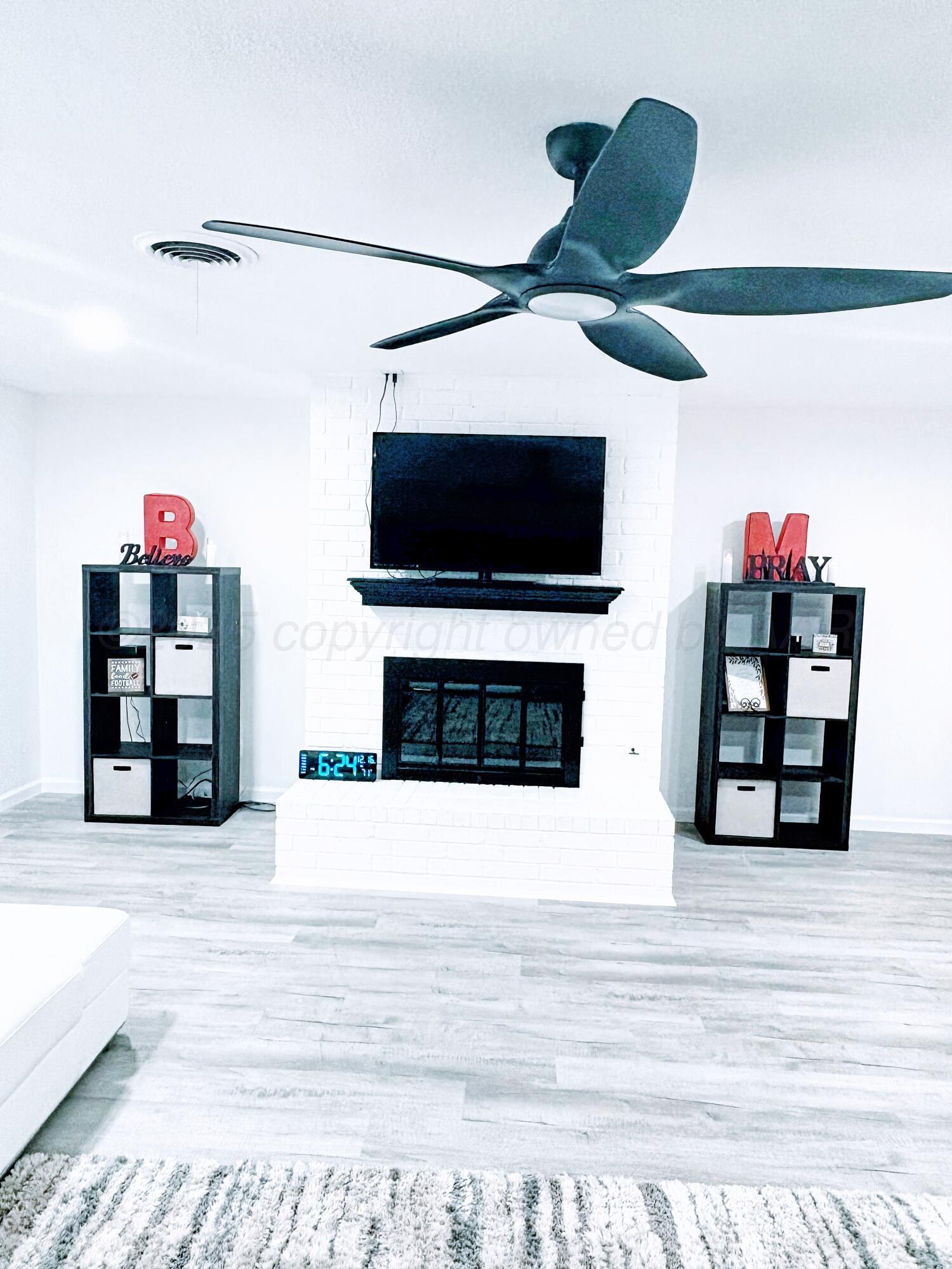 2310 Texas Street Perryton, TX 79070 - Photo 6 of 26 a living room with furniture and a flat screen tv