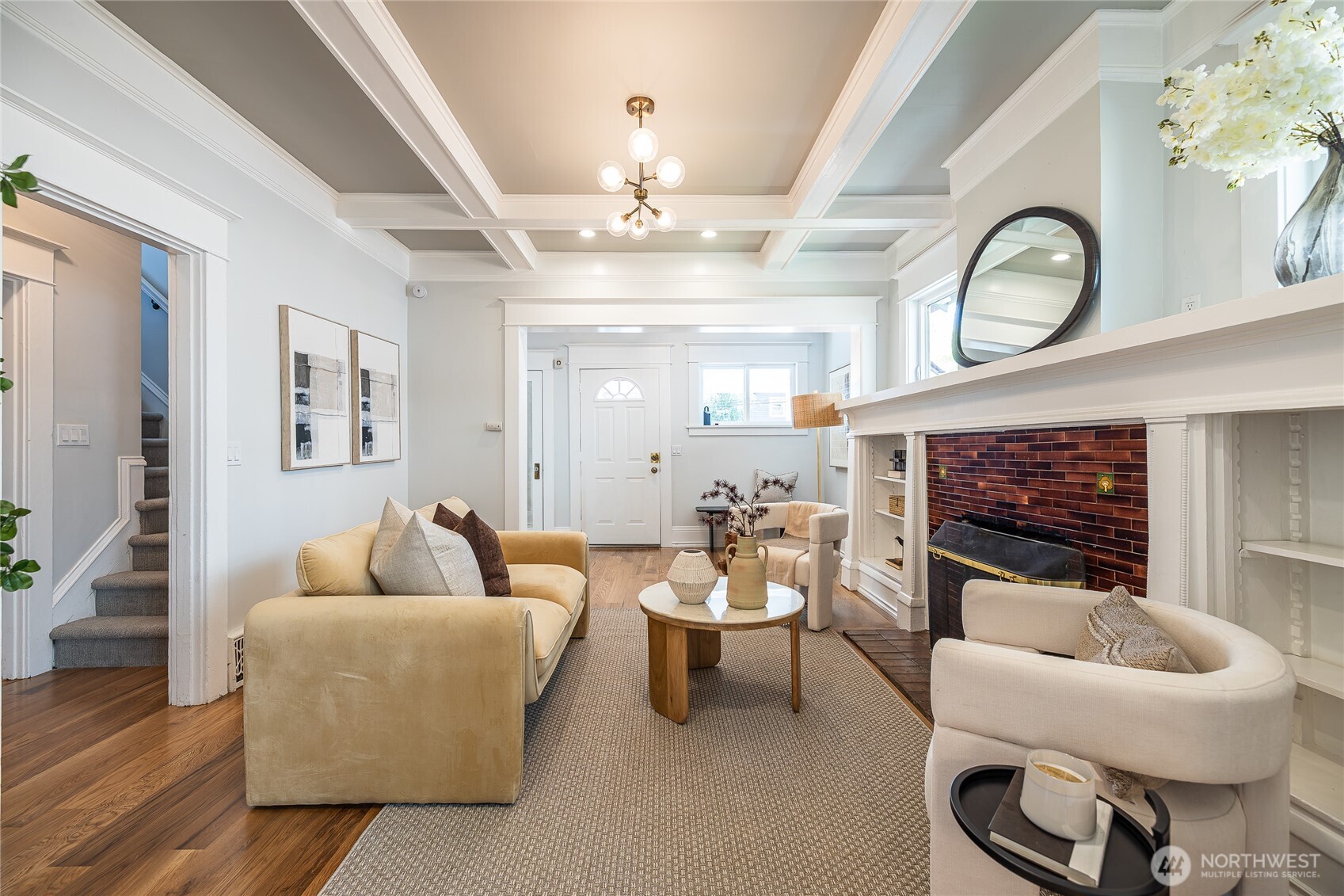 912 North 79th Street Seattle, WA 98103 - Photo 3 of 30 a living room with furniture a fireplace and a chandelier