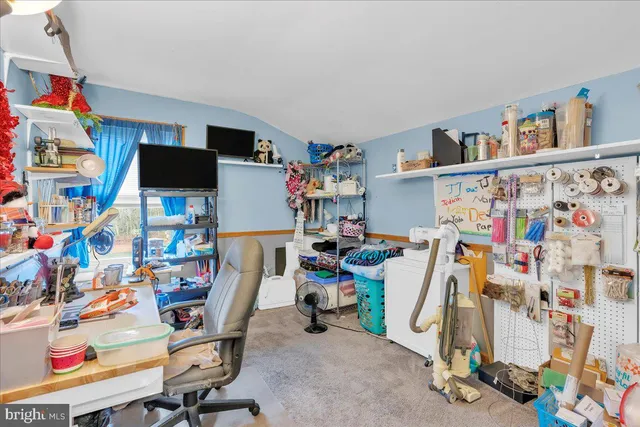 a room with furniture a small book shelf and a couch