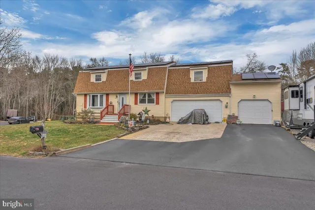 a front view of a house with garden and porch