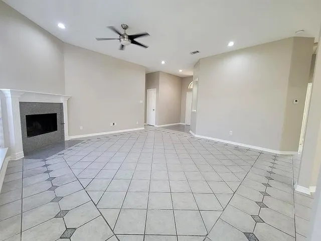 a view of an empty room with a ceiling fan