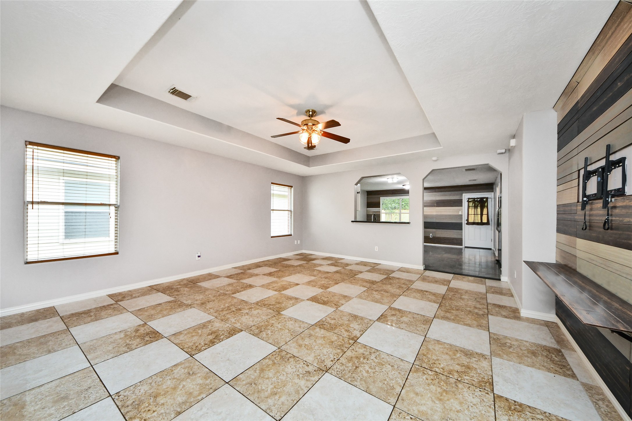 24019 Kingbriar Drive Spring, TX 77373 - Photo 12 of 41 A view from the living area toward the kitchen pass-through and dining space, perfect for keeping the conversation going with loved ones while preparing meals.
