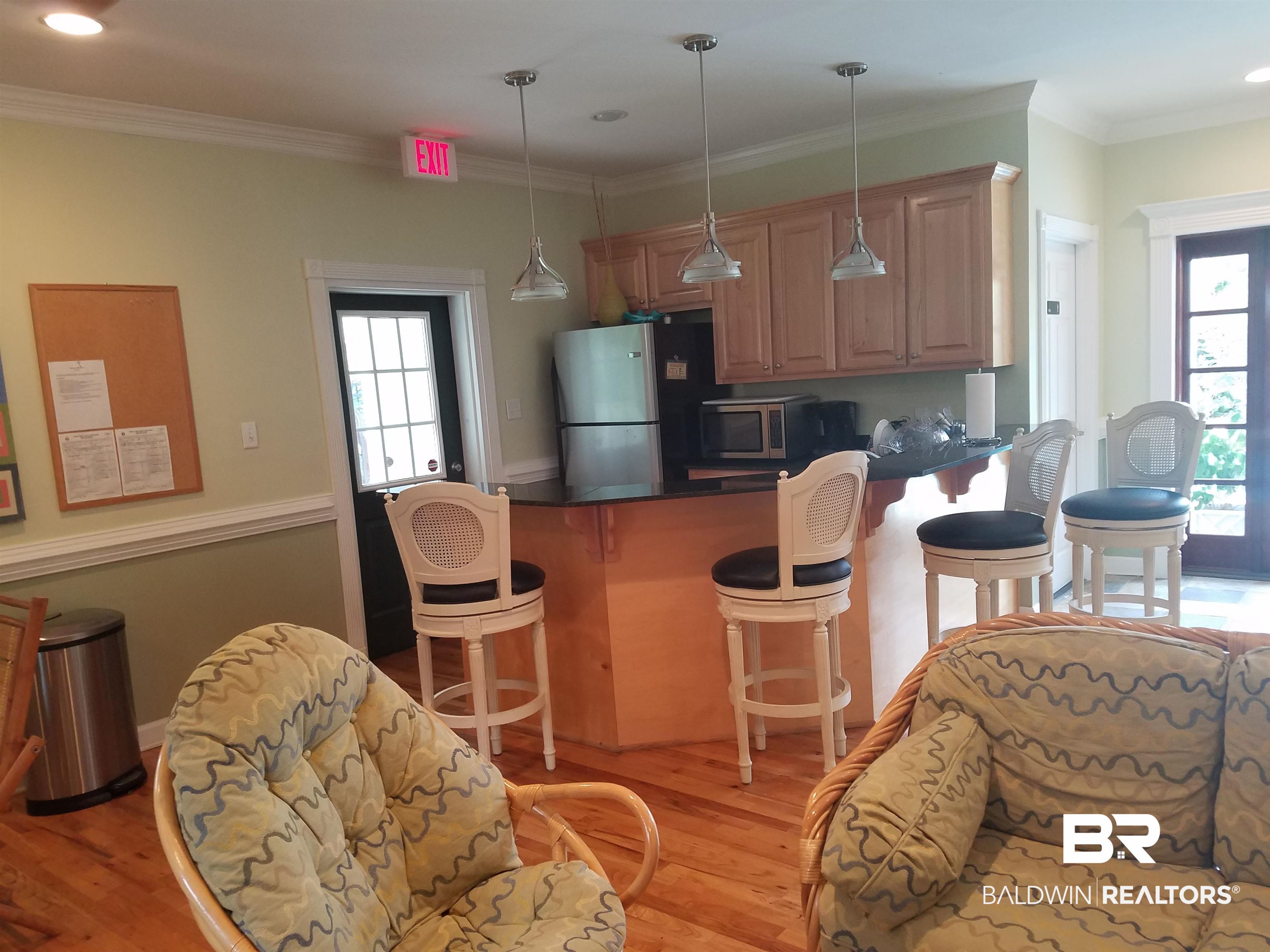 214 Upham Street, Unit 7C Mobile, AL 36607 - Photo 30 of 32 Kitchen with a kitchen breakfast bar, a peninsula, ornamental molding, appliances with stainless steel finishes, and recessed lighting