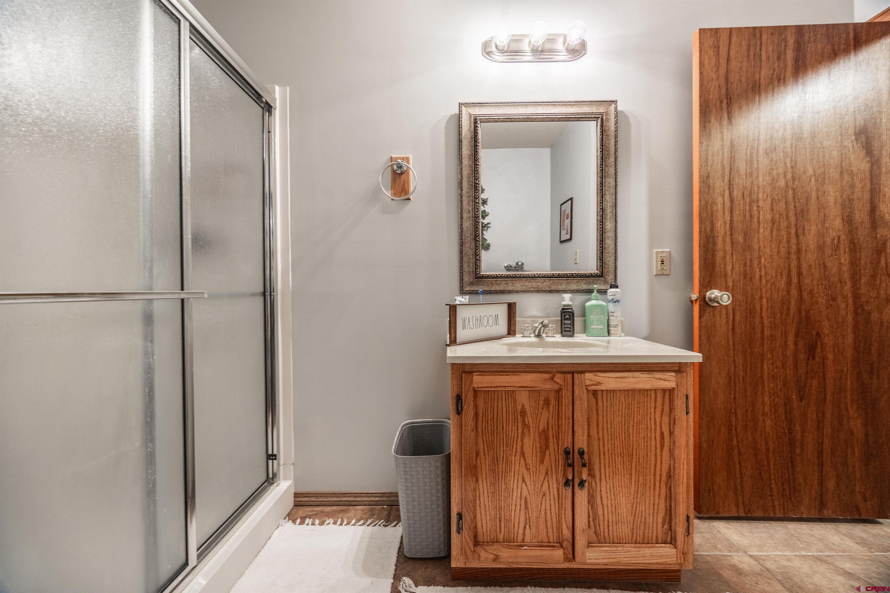 21186 Uintah Road Cedaredge, CO 81413 - Photo 21 of 45 a bathroom with a sink and a mirror