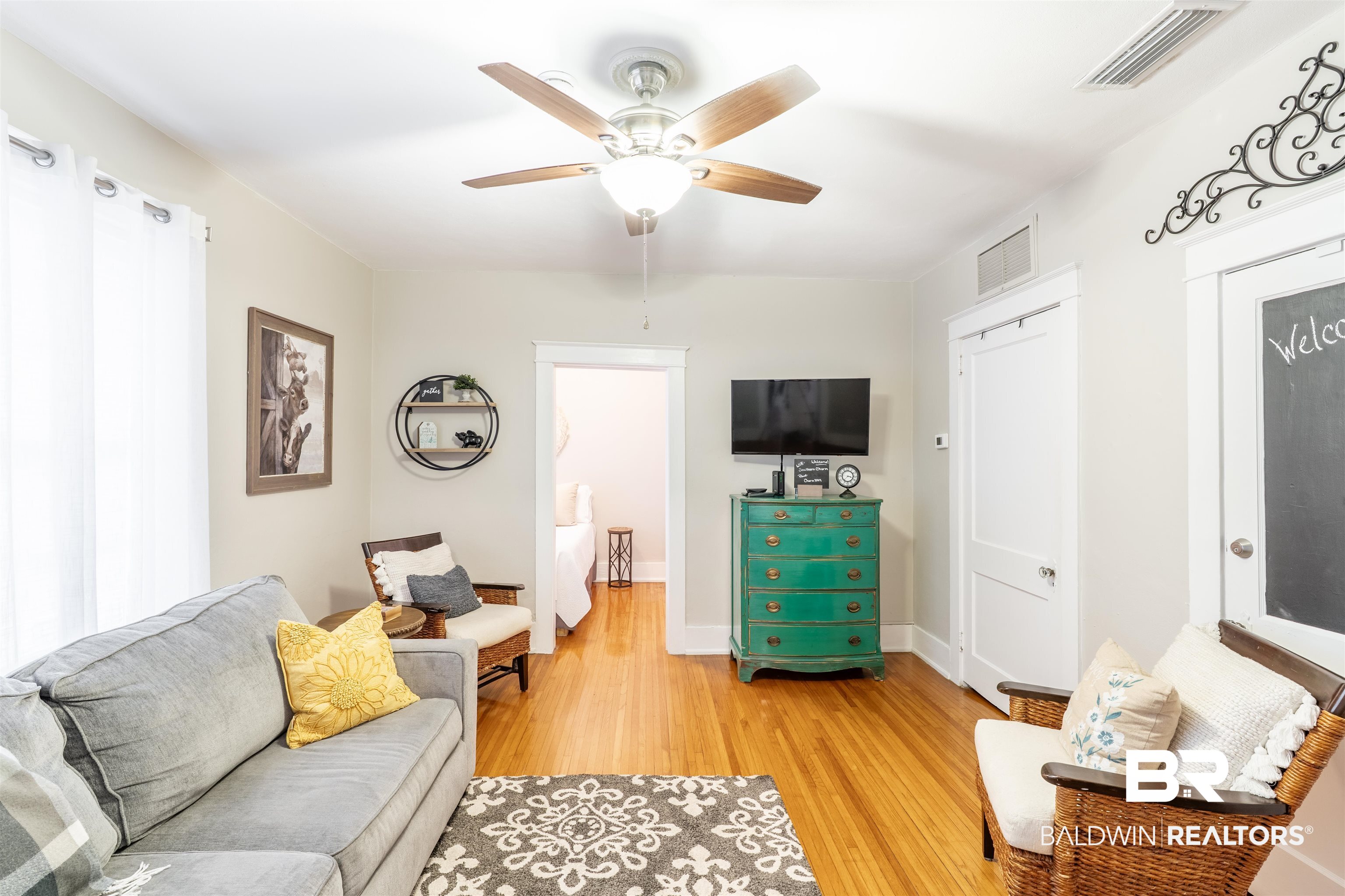 1600 Government Street, Unit 3F Mobile, AL 36604 - Photo 5 of 18 Living area with light wood-style floors, ceiling fan, and baseboards
