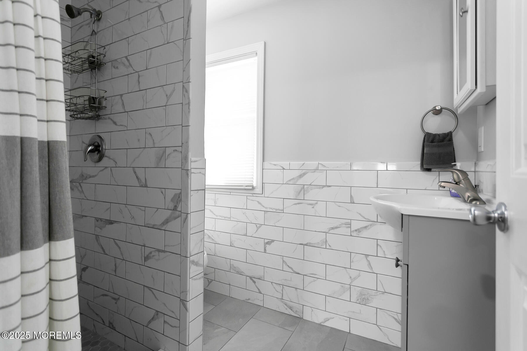 247 Sherman Avenue Seaside Heights, NJ 08751 - Photo 13 of 42 a bathroom with a sink and a shower