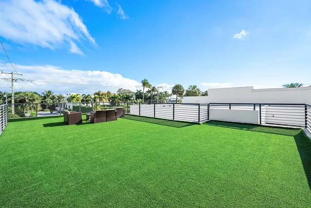 a view of a lake with houses in back