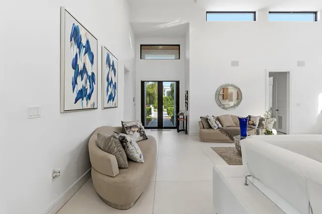 a large white kitchen with a large window